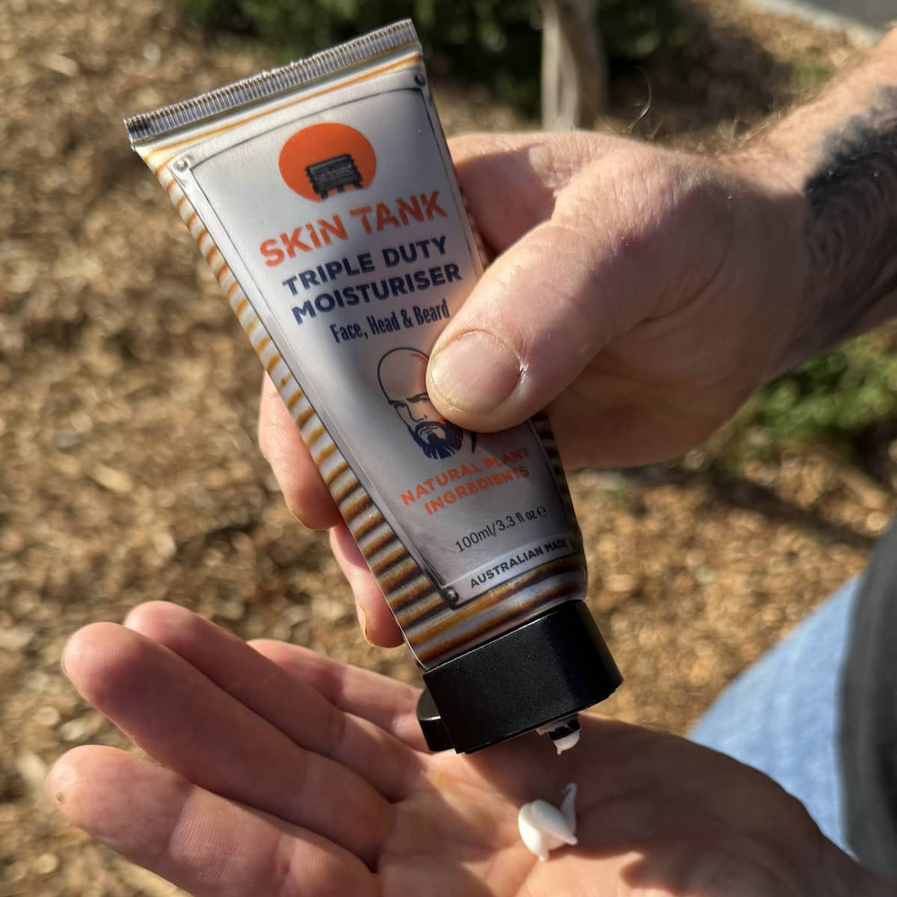 Man applying Skin Tank Triple Duty Moisturiser to hands outdoors – fast absorbing men's moisturiser for dry skin
